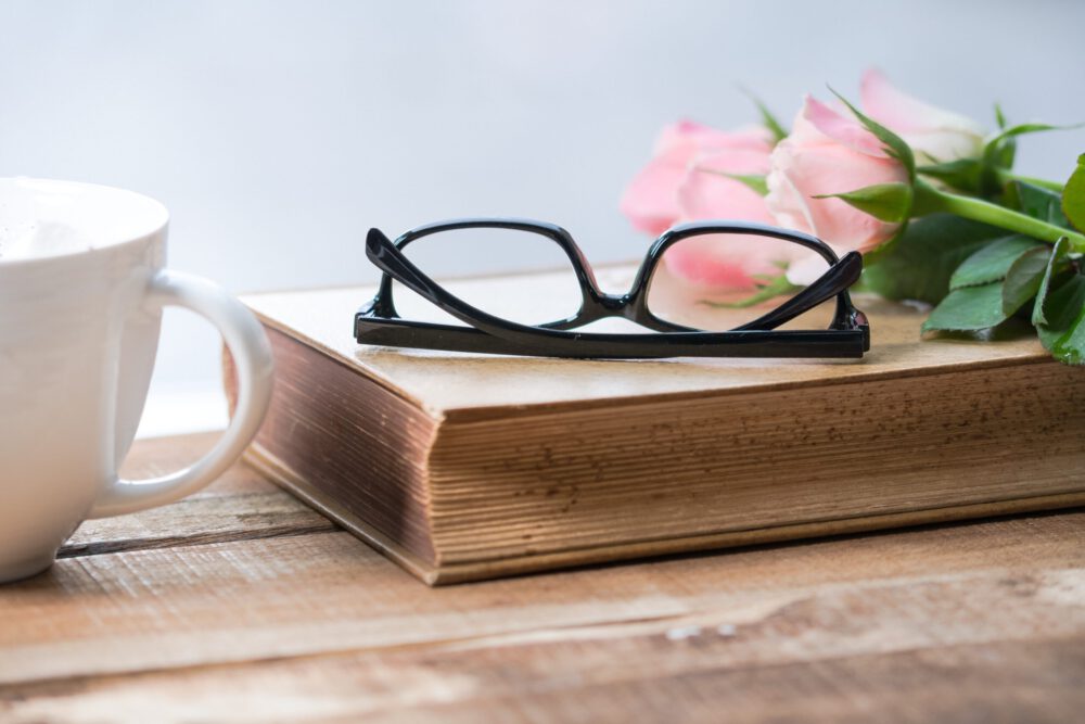 Book with glasses on top