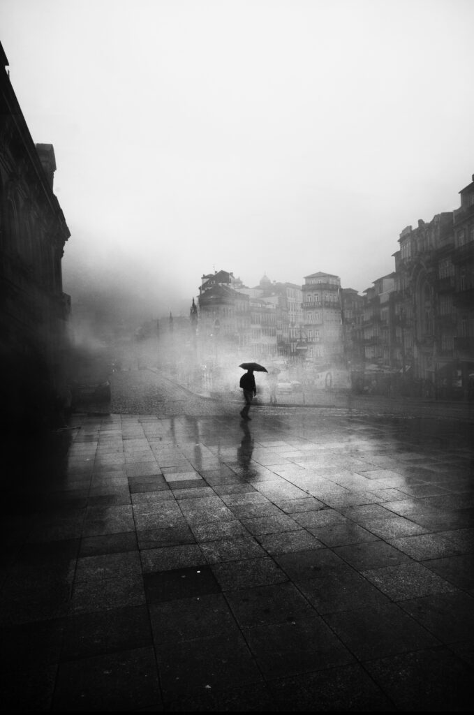 Gray picture with a person under umbrella